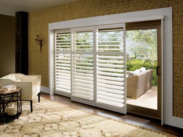Shutter Sliding Patio Door — Wide Louvers that tilt open and tilt close. Shutter window treatment using a By-Pass Track System. Panels stack behind one another